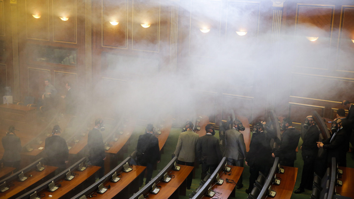 KOSOVO PARLIAMENT OPPOSITION TEAR GAS (Opposition lawmakers throw tear gas during a plenary session at Kosovo's parliament)