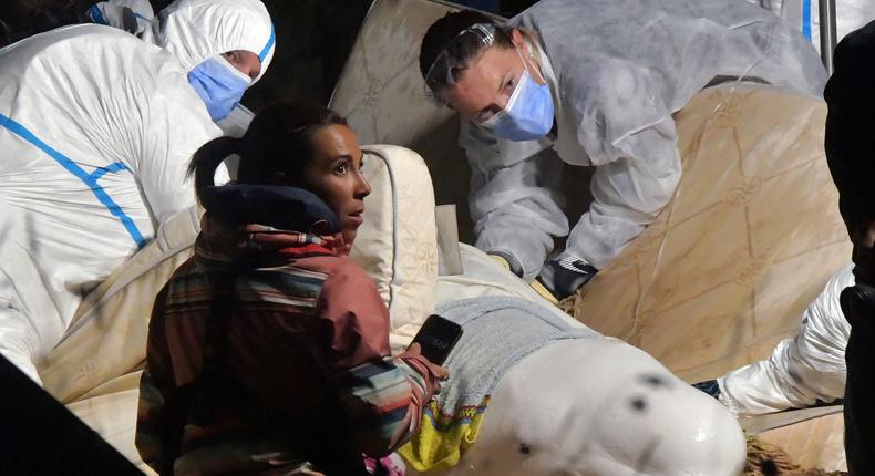 Veterinarians take care of a beluga whale that was stranded in the River Seine at Notre Dame de la-Garenne, northern France, on August 9, 2022.