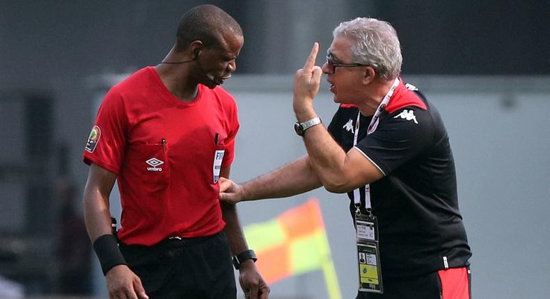 Tunisia manager Mondher Kebaier confronts referee Janny Sikazwe at full-time