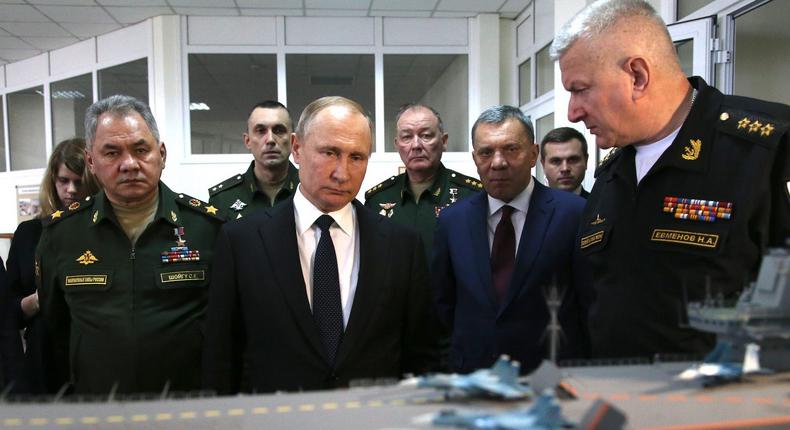 Russian President Vladimir Putin looks over a mockup of Russian aircraft carrier Admiral Kuznetsov while at a military exposition in Sevastopol, Crimea, January 9, 2020.