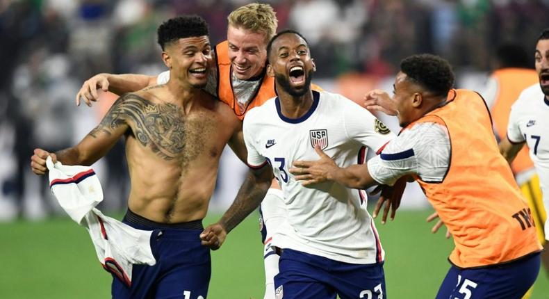 USA's Miles Robinson (left) celebrates winning the CONCACAF Gold Cup final with a 1-0 victory over Mexico in Las Vegas Creator: Patrick T. FALLON