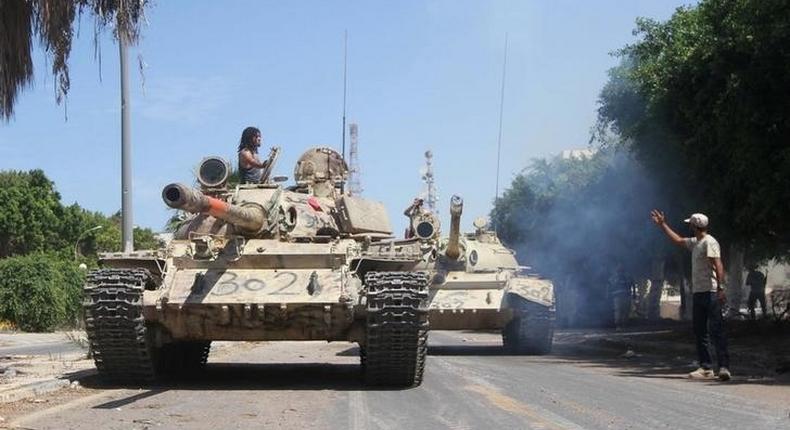 Members of Libyan forces allied with the U.N.-backed ride their tanks during a battle with Islamic State militants in Sirte, Libya September 6, 2016. 