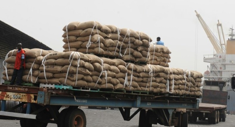 In January 2011, an Ivorian worker stands on a truck carrying bags of cocoa beans, 15 percent of Ivory Coast's GDP and more than 50 percent of its export earnings, according to the World Bank