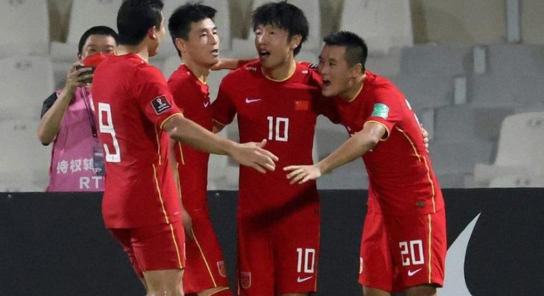 Chinese players celebrate beating  Syria at the Sharjah Football Stadium to secure their place in the final qualifying round for Qatar 2022 Creator: Karim SAHIB