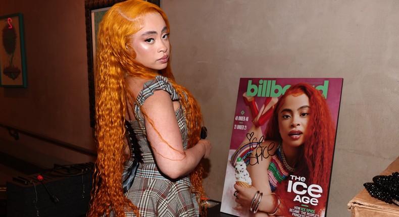 Ice Spice standing next to her Billboard cover image.Christopher Polk / Getty Images