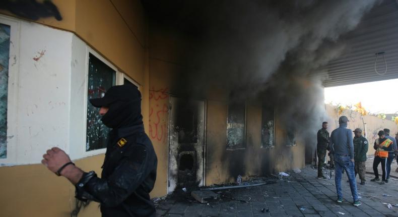 Smoke billows from the entrance of the US embassy in Baghdad after pro-Iran protesters tried to break into the building during a rally to vent anger over deadly US air strikes