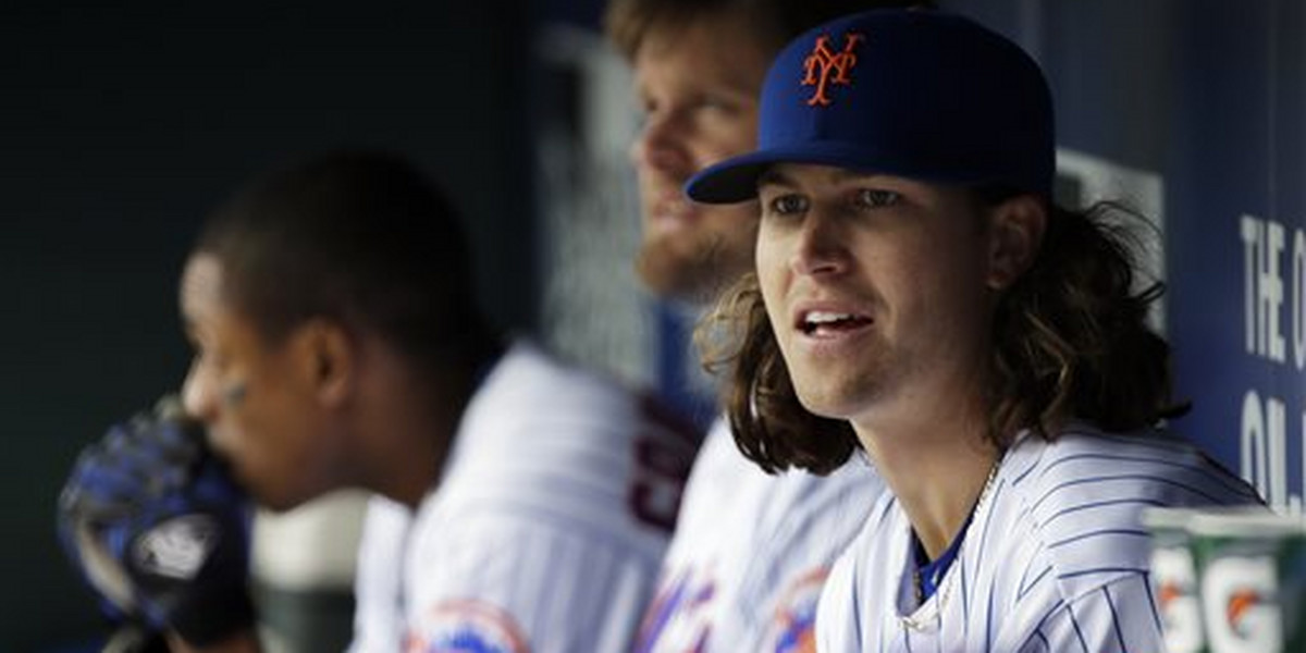 FILE - In this April 8, 2016, file photo, New York Mets pitcher Jacob deGrom (48) watches from the dugout during the fourth inning of a baseball game against the Philadelphia Phillies in New York. The Mets placed deGrom on the family medical emergency list because of health complications involving his newborn child. (AP Photo/Julie Jacobson, File)
