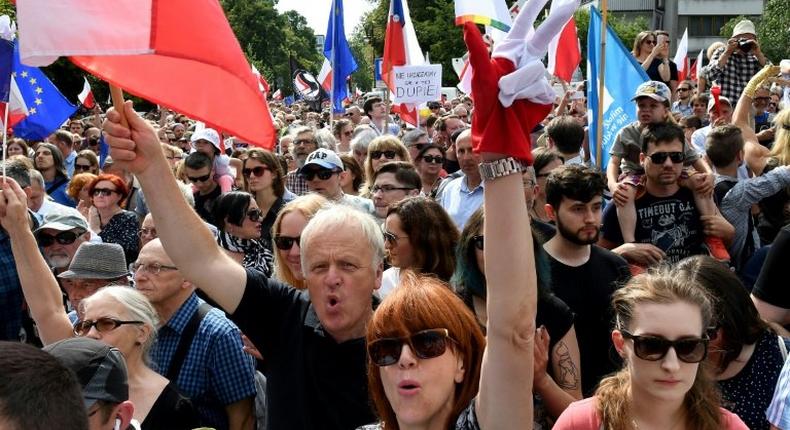 Poles rally in Warsaw to protest against court reforms they see as undermining the separation of powers