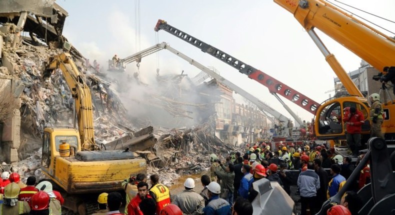 Emergency personnel search on January 20, 2017 for victims in the wreckage of the 15-storey Plasco building in the capital Tehran, which collapsed the previous day