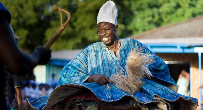 Man dancing happily in smock