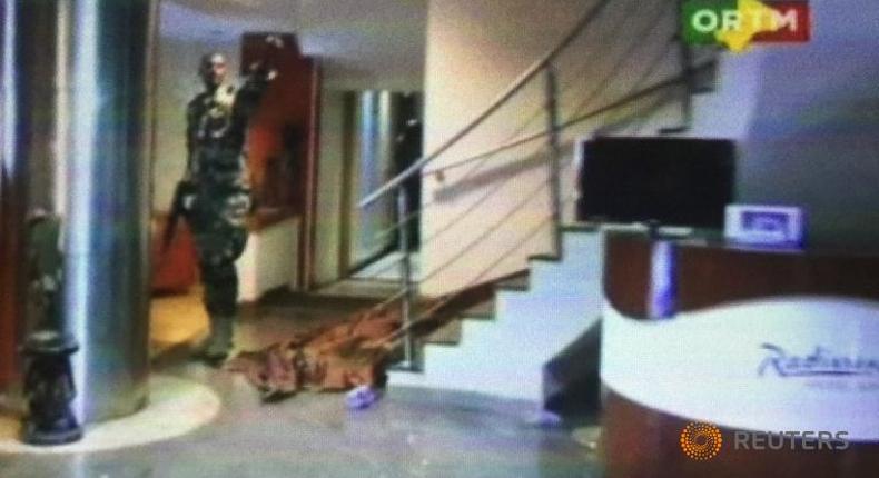 Mali hotel attackers dig in on seventh floor, gunfire heard