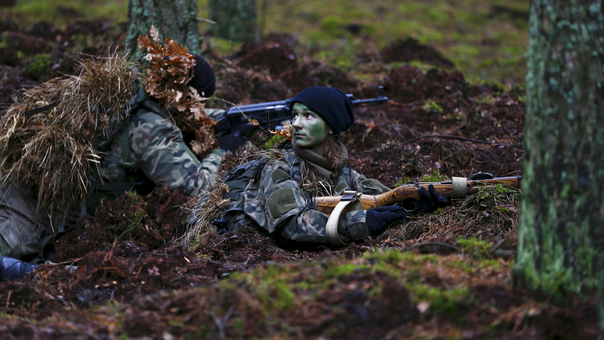 Participiants secure a position during a territorial defence training organised by paramilitary group SJS Strzelec (Shooters Association) in the forest near Minsk Mazowiecki