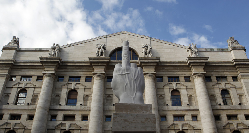 A sculpture called " crippled hand" from Italian sculptor Maurizio Cattelan is placed in front of stock exchange palace in Milan