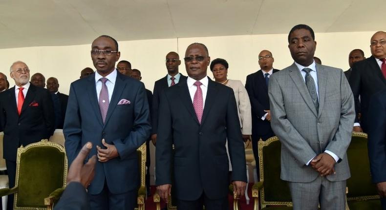 Haitian President Jocelerme Privert (C) stands with the new Prime Minister of Haiti, Enex Jean-Charles (R) and former Prime Minister Evans Paul (L) during the installation of the new government in Port-au-Prince March 28, 2016