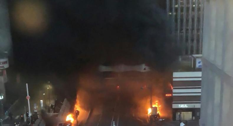 A picture shows vehicles and bins burning near the Gare de Lyon rail station in Paris on February 28, 2020; police said they tried to stop protesters who set alight garbage bins and scooters