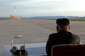 FILE PHOTO: North Korean leader Kim Jong Un watches the launch of a Hwasong-12 missile in this undat