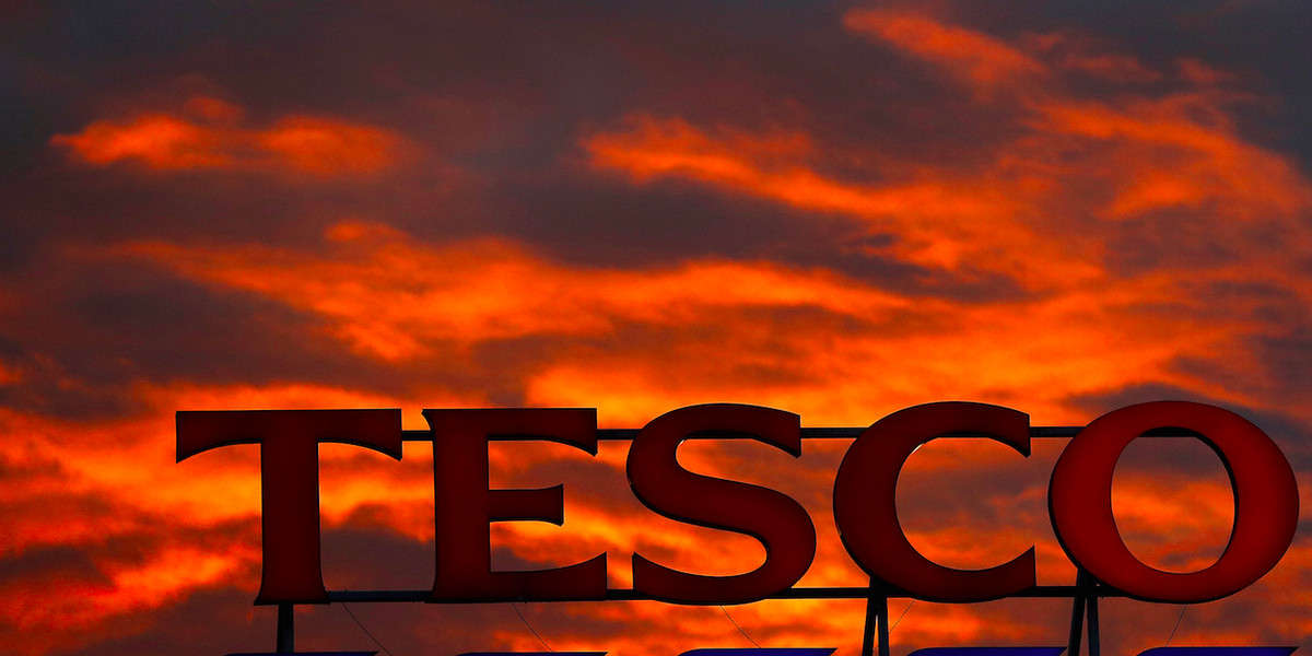 A company logo is pictured outside a Tesco supermarket in Altrincham northern England, April 16, 2016.