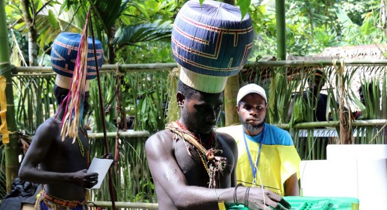 Young Upe men cast their votes in the Bougainville Referendum at the men's only polling station in Teau Bougainville, Papua New Guinea.