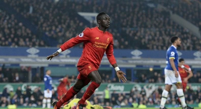 Liverpool's Senegalese midfielder Sadio Mane celebrates scoring his team's first goal during the English Premier League football match between Everton and Liverpool at Goodison Park in Liverpool, north west England on December 19, 2016