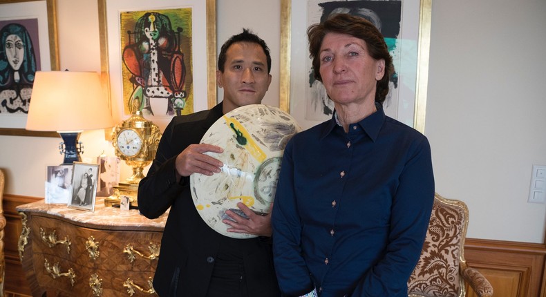 Marina Picasso, right, granddaughter of artist Pablo Picasso, and her son Florian Picasso pose with a ceramic art-work of Pablo Picasso in Cologny near in Geneva, Switzerland, Tuesday, Jan. 25, 2022.