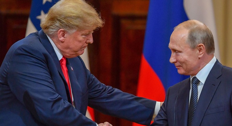 Then-President Donald Trump and Russian President Vladimir Putin shake hands in Helsinki, Finland on July 16, 2018.