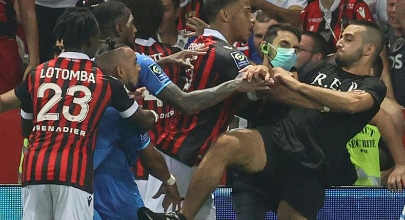 The trouble started when Marseille's Dimitri Payet (2nd L) reacted to being pelted with bottles by the Nice supporters