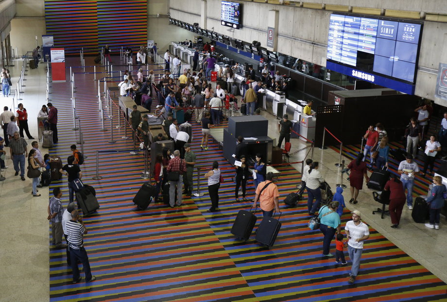 Passengers walk at the Simon Bolivar airport in La Guaira, outside Caracas, September 23, 2013.