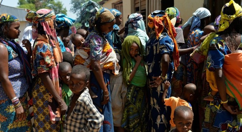 Women and children wait in line in the Begoua district, northeast of Bangui, to receive humanitarian and medical aid in 2014