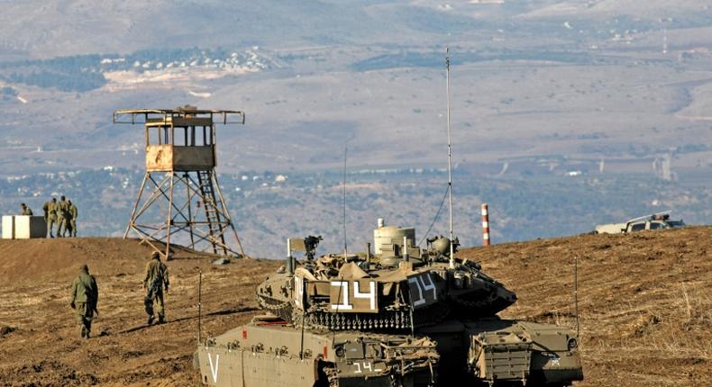 Israeli troops equipped with armoured vehicles survey neighbouring Syria from the Golan Heights, a strategic plateau Israel seized from Syria in the Six-Day War of 1967