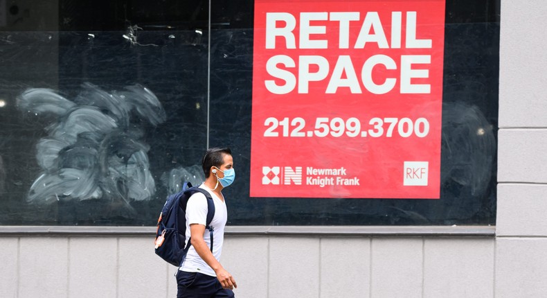 A person wears a protective face mask near an empty store in the NYC Flatiron District.Photo by Noam Galai/Getty Images