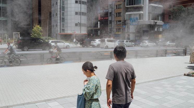 Vízpárával védekeznek a hőhullám ellen Japánban június 26.-án. A hőguta elkerüléséhez be kéne kapcsolni a klímákat, de ez csak akkor megy, ha 37 millió ember lekapcsolja otthonában a lámpákat. / Fotó: Northfoto