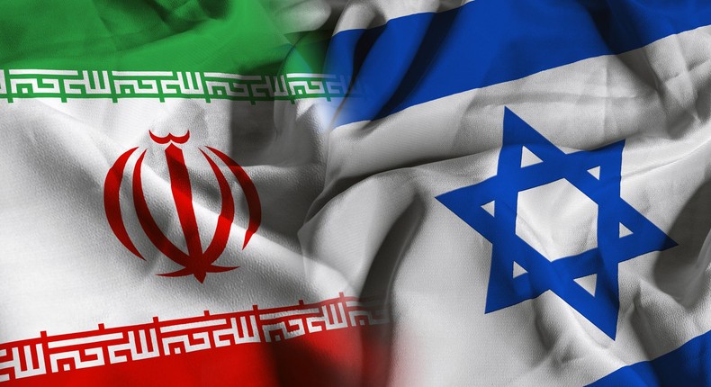 The flags of Iran, left, and Israel, right.Manuel Augusto Moreno/Getty Images