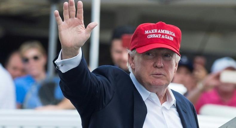 US President Donald Trump waves to well wishers as he arrives at the 72nd US Women's Open Golf Championship at Trump National Golf Course in Bedminster, New Jersey