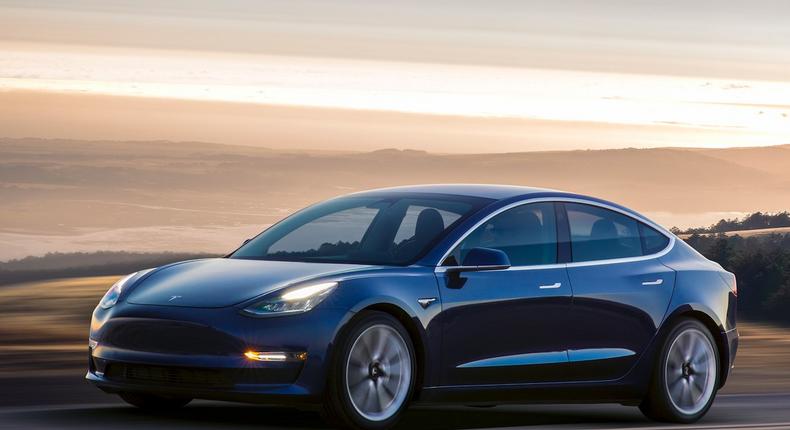 A Tesla Model 3 with the deep blue metallic paint job.