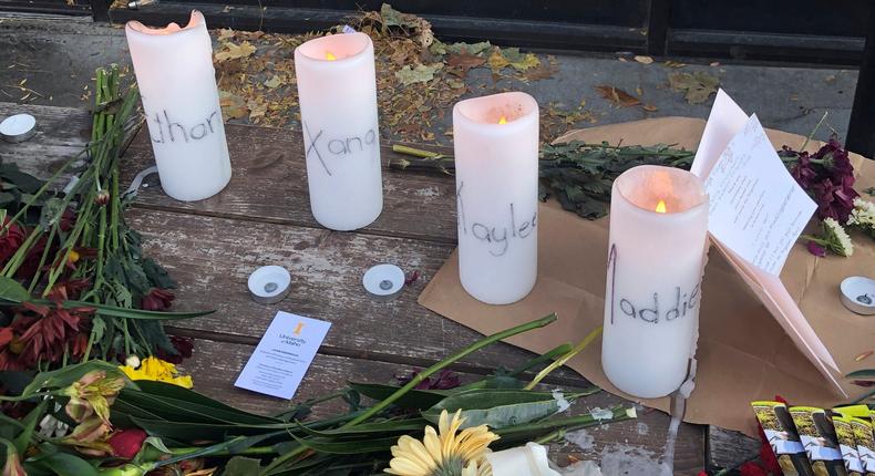 Candles and flowers are left at a make-shift memorial honoring four slain University of Idaho students outside the Mad Greek restaurant in downtown Moscow, Idaho, on Tuesday, Nov. 15, 2022.AP Photo/Nicholas K. Geranios