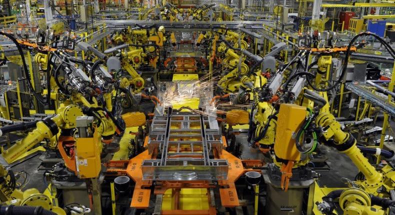 Robotic arms spot welds on the chassis of a Ford Transit Van under assembly at the Ford Claycomo Assembly Plant in Claycomo