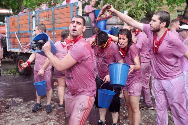 A reveller throws a bucket of wine during the Batalla de Vino (Wine Battle) in Haro