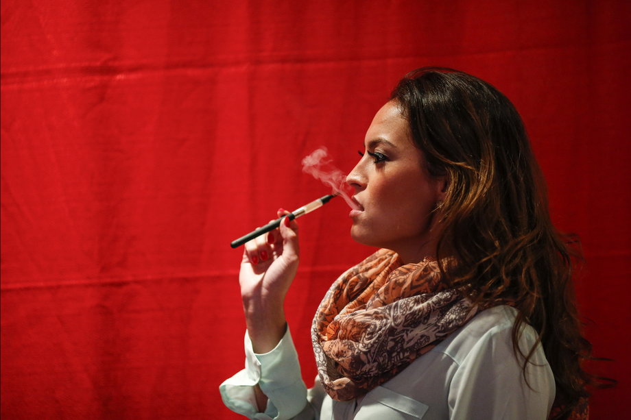 A woman uses a electronic vaporizers with cannabidiol (CBD)-rich hemp oil while attending the International Cannabis Association Convention in New York, October 12, 2014.