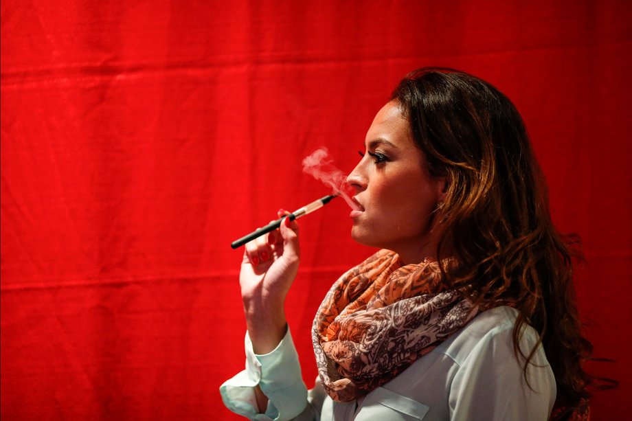 A woman uses a electronic vaporizers with cannabidiol (CBD)-rich hemp oil while attending the International Cannabis Association Convention in New York, October 12, 2014.