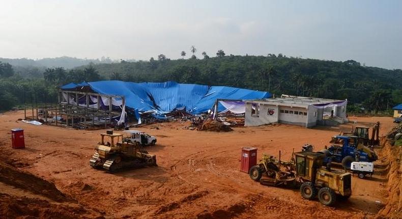 Heavy duty equipment and machinery are seen at the premises of the collapsed church in Uyo, Nigeria December 11, 2016 REUTERS/Stringer