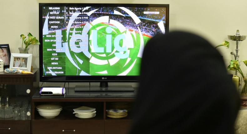 A picture taken January 20, 2020, shows family members watching Qatar's beIN sport channel at their home in the Saudi capital Riyadh