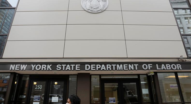 A person walks by the entrance of the New York State Department of Labor offices in Brooklyn, which is closed to the public due to the coronavirus pandemic.REUTERS/Andrew Kelly