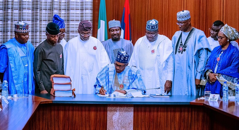 President Muhammadu Buhari signs N10.594trn 2020 Appropriation Bill into law. In attendance were: Vice President Yemi Osinbajo, President of the Senate, Ahmad Lawan, Speaker of the House of Representatives Hon. Femi Gbajabiamila, SGF Boss Mustapha, Minister of Finance, Budget and National Planning, Zainab Shamsuna Ahmed, and others. [Twitter/@Opetuyii]