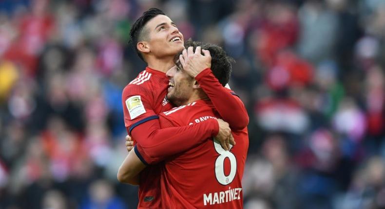 James Rodriguez and Javi Martinez celebrate the goal that took them level on points with Borussia Dortmund