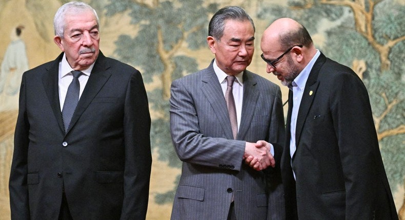 China's Foreign Minister Wang Yi brokered a truce between Mahmoud al-Aloul, a leader of the Palestinian group Fatah and Mussa Abu Marzuk, a leader of Hamas, in July 2024.PEDRO PARDO via Getty Images