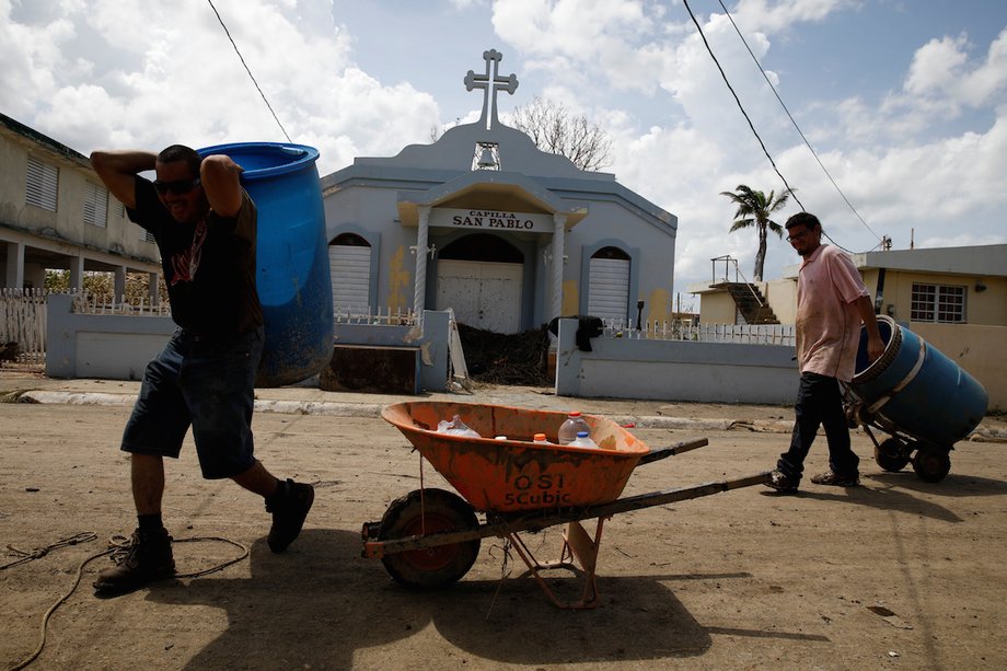 Men carrying a container of water in Toa Baja, Puerto Rico.