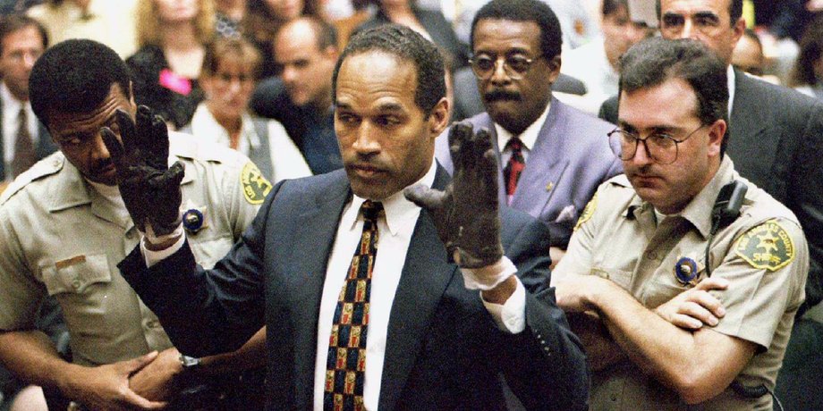 O.J. Simpson holds up his hands to the jury.