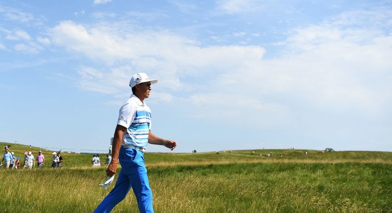 Rickie Fowler walks the Erin Hills golf course prior to the U.S. Open.