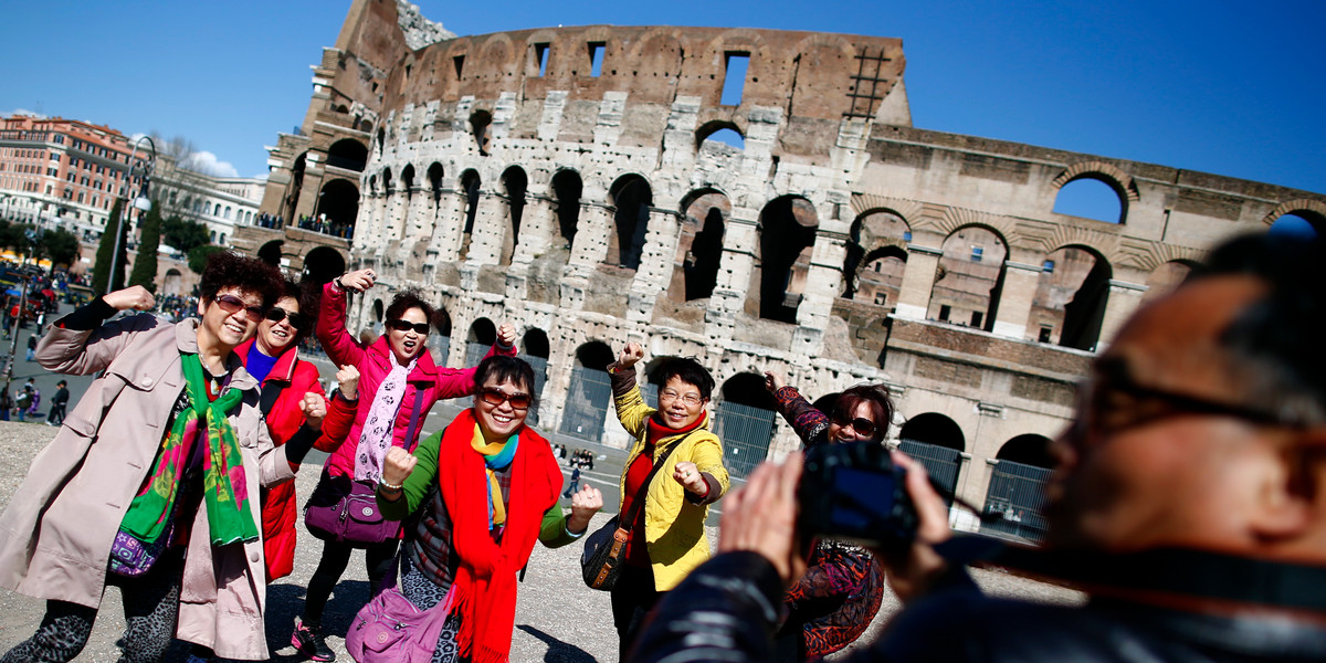 Tourists in front of the Colosseum in Rome.