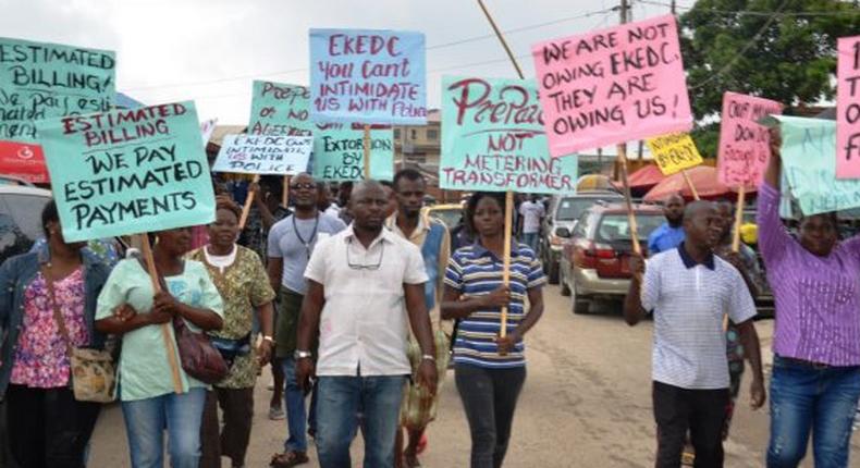 An illustrative photo of protesters carrying placards with messages to electricity distribution companies  [nigeriaelectricityhub]